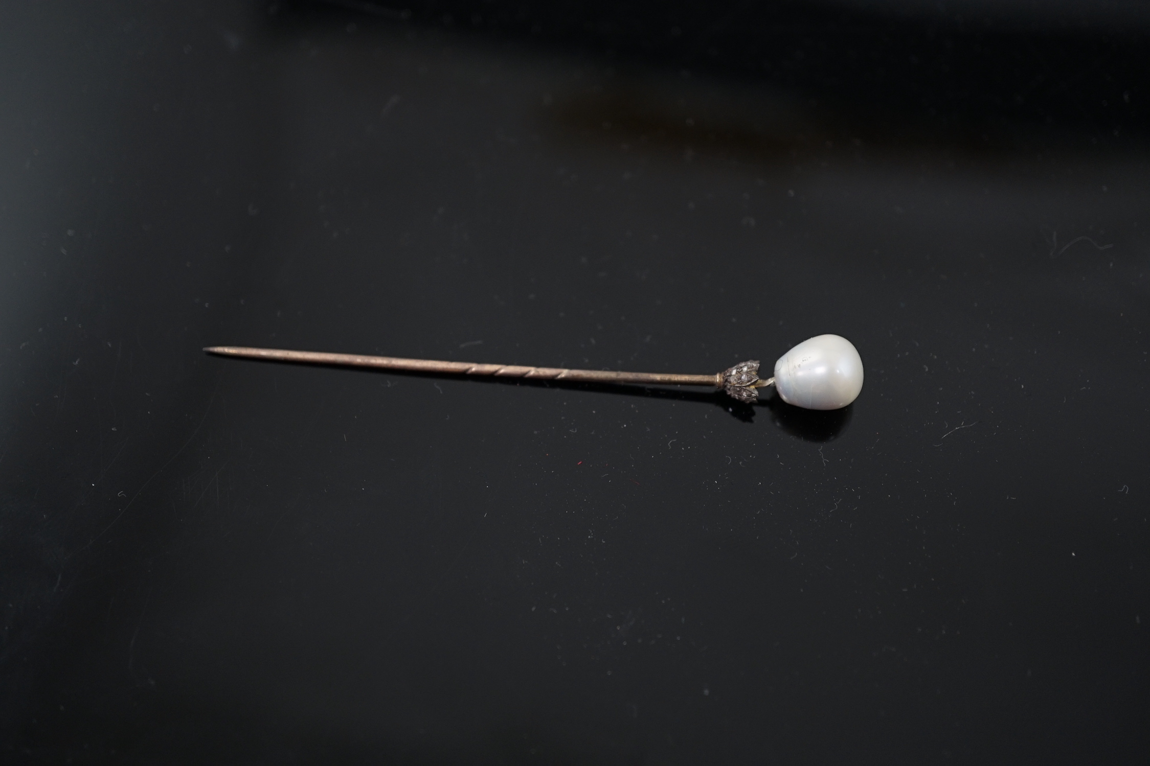 A Victorian gold, single stone part drilled natural saltwater pearl and rose cut diamond chip set stick pin